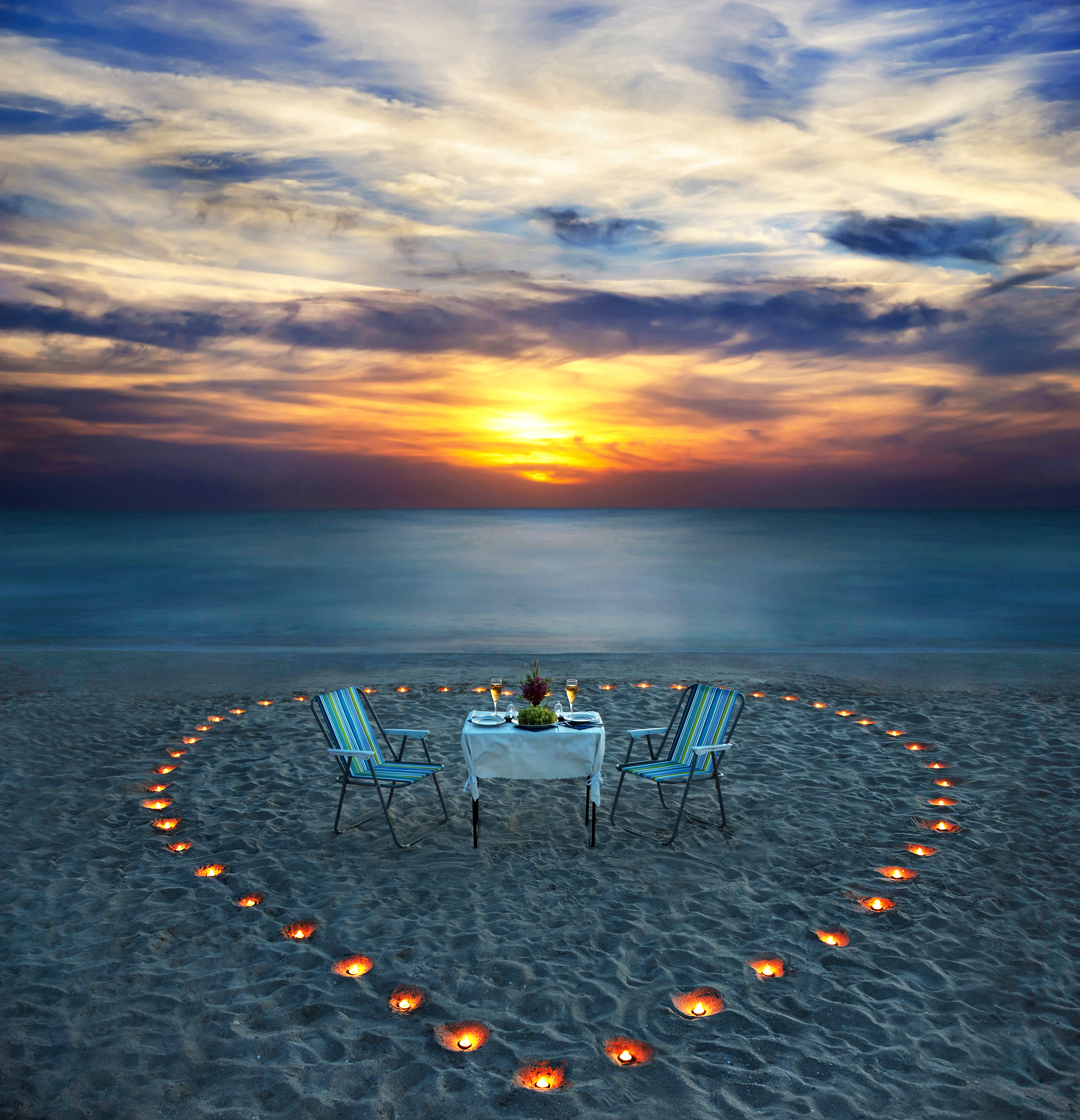 romantic dinner on sea beach with candles